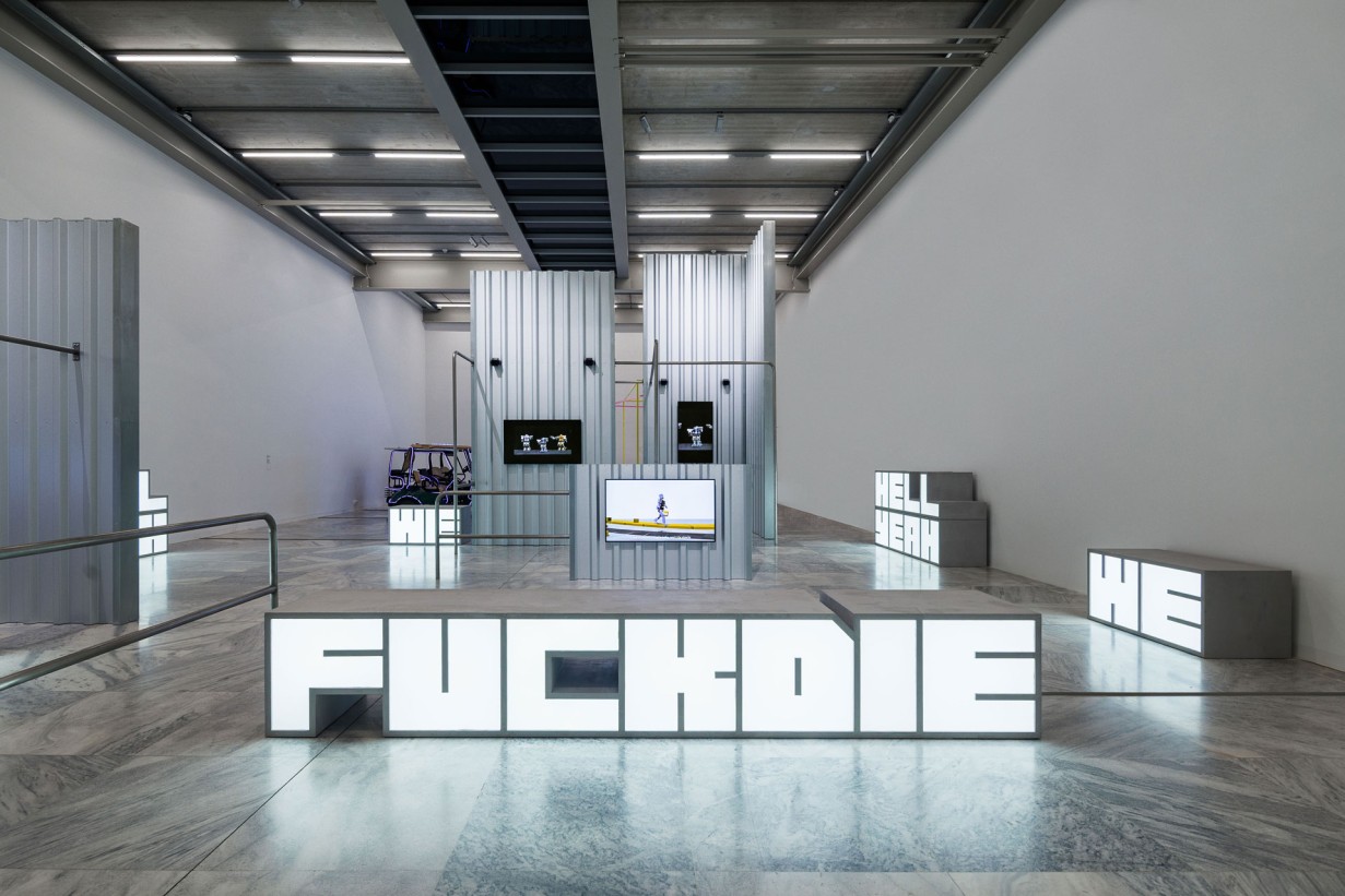 Exhibition space with oversized lettering Hell Yeah We Fuck Die