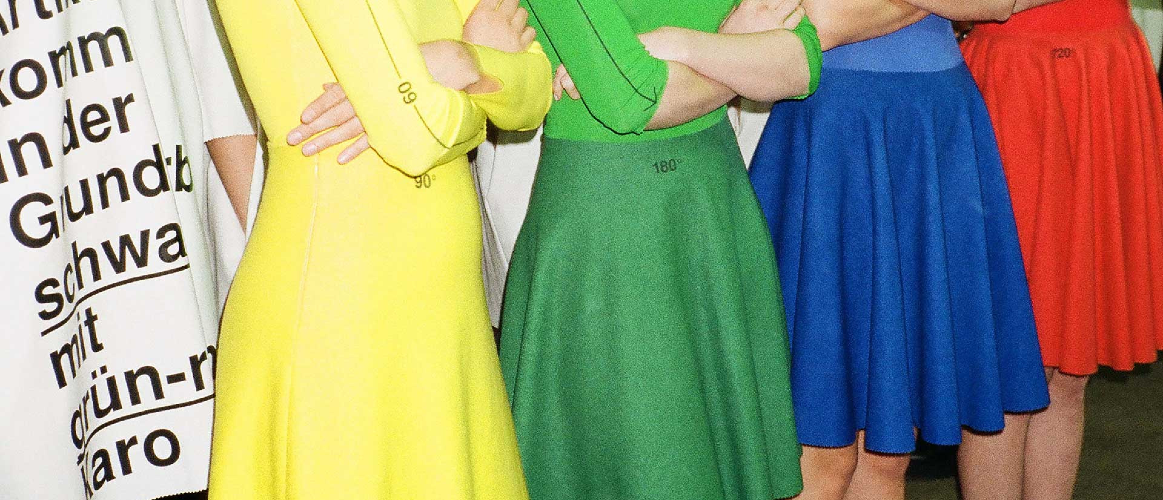 Four models, you can see only the torso, one yellow, one green, one blue and one red outfit.